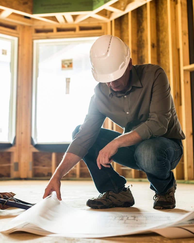 Contractor reading plans on site